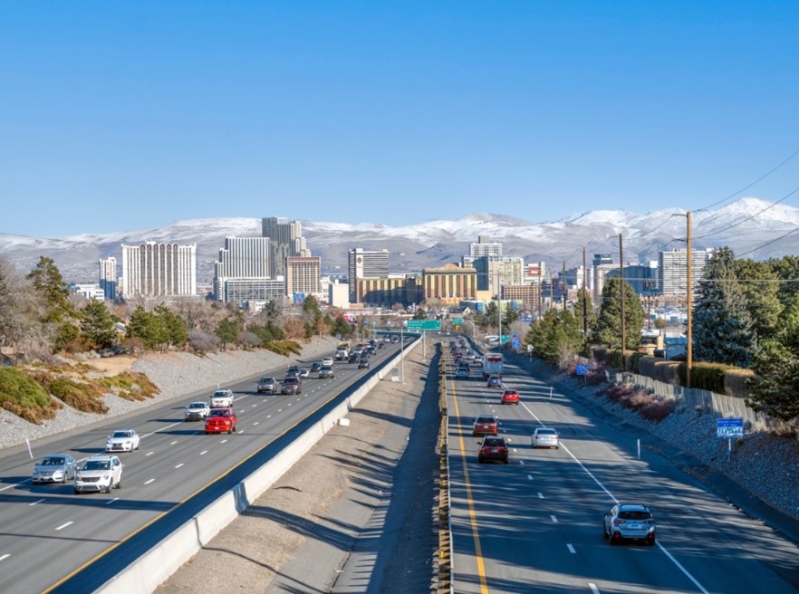 Cars travel on I-80, with Reno visible in the background